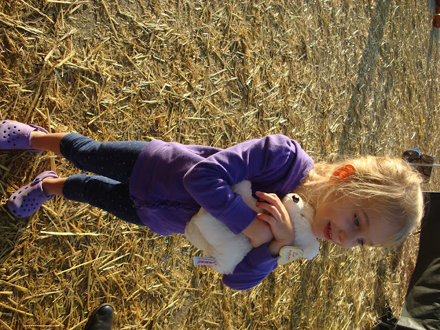 Young girl giving stuffed animal a big hug