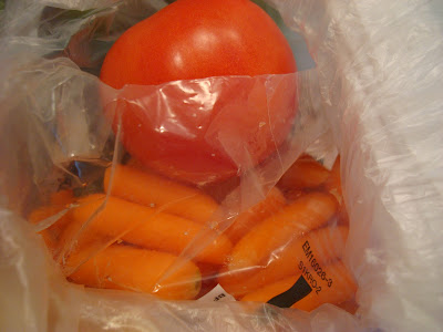 Carrots and tomato in bag