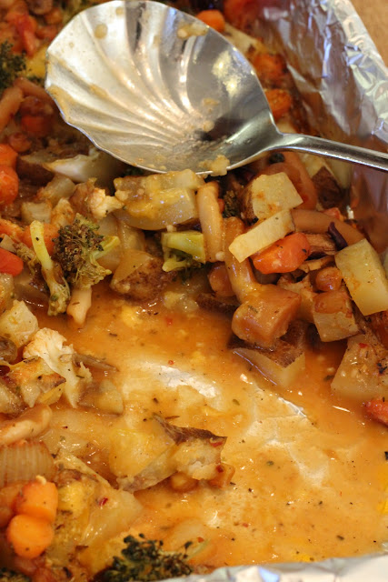 Serving spoon with some of the Cheezy Vegetable Bake missing