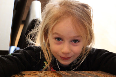 Young girl leaning over countertop