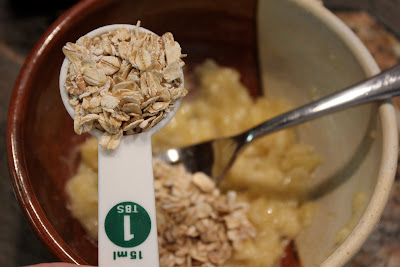 oats being adding to mashed banana