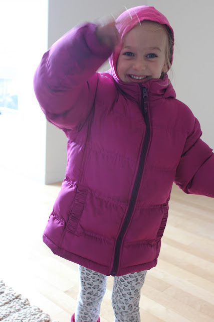 Close up of young girl in jacket with arm raised