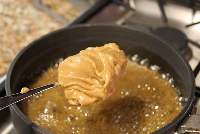 Scoop of peanut butter being added to butter mixture  - 19