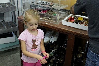 Young girl trying on pink bracelet 