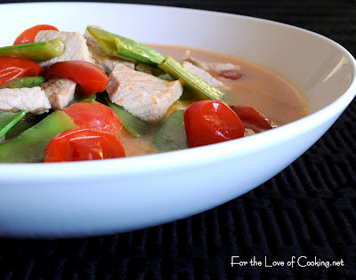 red curry pork with tomatoes and snow peas over jasmine rice