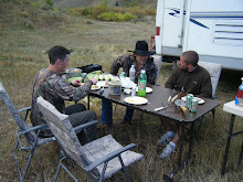 Guys eating at camp