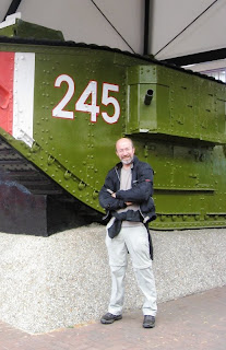 Mr A in front of a military tank