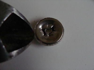 Treasured Tacks: DIY Push Pins from Vintage Buttons and Jewels 8 flattening the back of a metal button with nippers