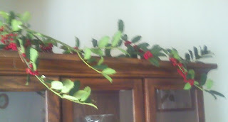 holly branches over china cabinet