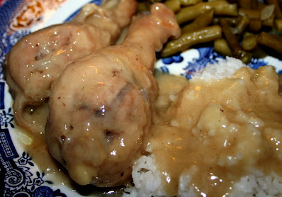 Chicken is first lightly fried, then a gravy is prepared with the seasoned flour and pan drippings, the chicken is dunked right in the gravy and slow stewed or baked.