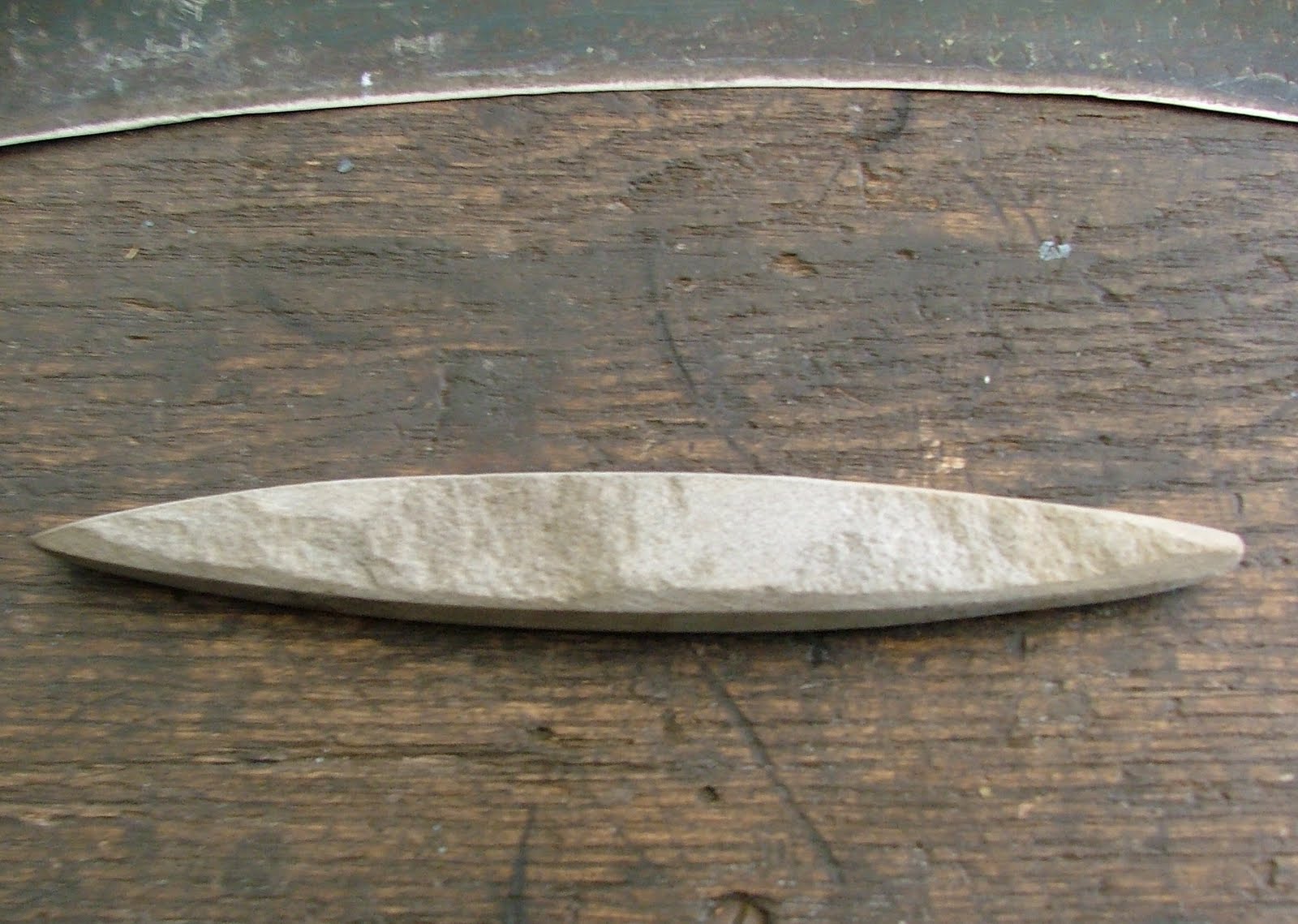 Rural Blacksmith Sharpening the Scythe by hammer and stone.