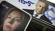 Campaign posters for Likud Party leader Benjamin Netanyahu, top, and his rival,