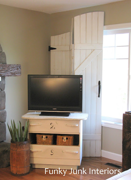 Learn how to easily build your own wooden gate window screens on a room divider with plank wood! Perfect for pet households and they resemble gates or barn doors! Click to full tutorial.