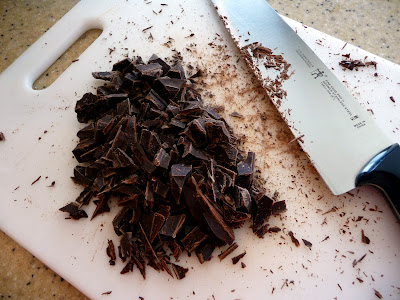 Chopped chocolate on a cutting board. 