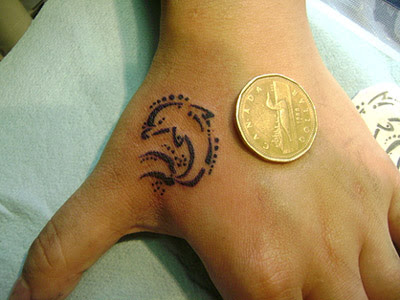 Hand Tribal Dolphin tattoo