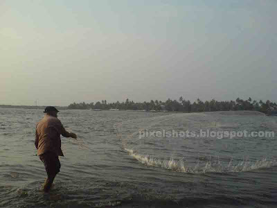 kerala fisherman,beach fishing photos,throwing fish net,fisherman throwing net in the beach of fort cochin kerala,casting fish net