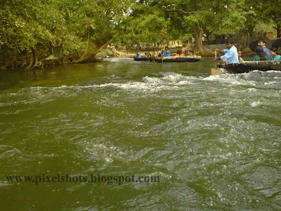 fast green river water current in kauveri river tamilnadu,photograph taken from basket boat journey in a tour trip