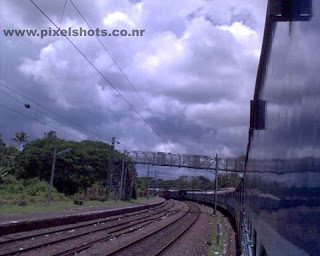 cloudy sky photograph taken from a train in kerala
