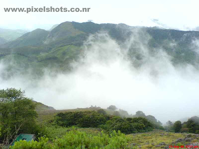 munnar-misty-hills,munnar-photos,photos from munnar rajamala,beautiful scenery from munnar kerala showing dense mist raising up between the hills from the valley