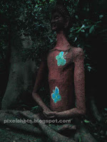 meditating man inside forest,sculptures in sculpture park inside forest,ecotourism sculptures of Kerala thenmala india kollam,sculpture man buddha with butterflies on his body