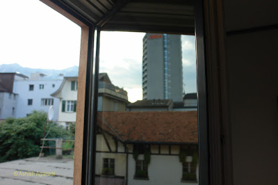 Photo of view of Interlaken through a reflection in a glass window