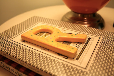 yellow R on bedside table