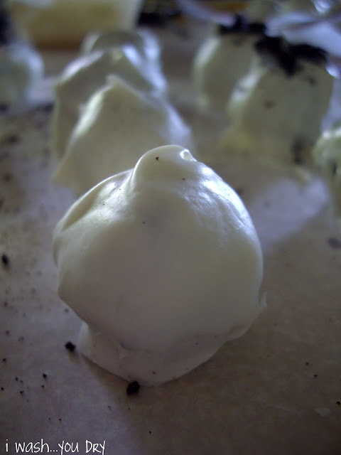 White chocolate dipped Oreo balls on a pan.