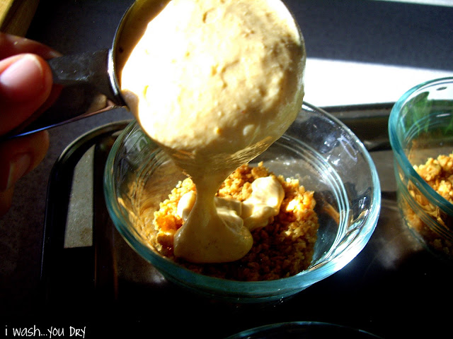 Batter being poured into bowls on top of graham cracker crusts. 