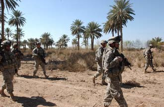 U.S. Army Soldiers from A Battery, 2nd Battalion, 15th Field Artillery Regiment, 10th Mountain Division (Light Infantry), along with Iraqi Army Soldiers, conduct a foot patrol through an area that has been frequented with attacks on Coalition forces, March 4. U.S. Army photo by Sgt. Jacob H. Smith.