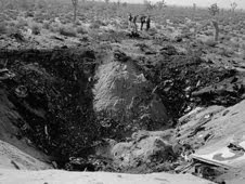 Investigators pore over the site of the nose-first, high-impact JF-104A crash that left this large crater in the desert near Edwards Air Force Base in December 1962. NASA test pilot Milton O