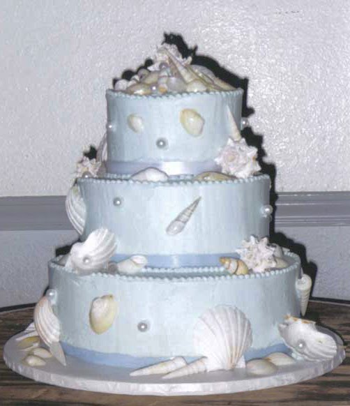 Two tier tiffany blue wedding cake adorned with white sea shells