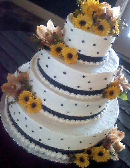 Yellow and white polka dot and stripes wedding cake with sunflower cake 