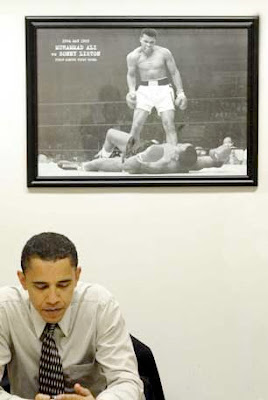 Barack Obama under photo of Muhammad Ali