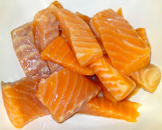 Raw salmon sashimi, chopped and tossed with lemon juice