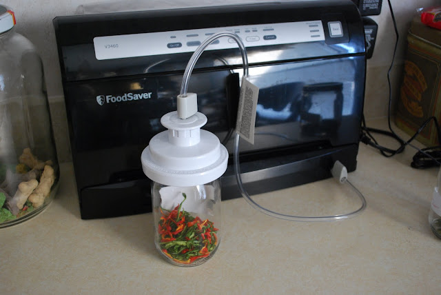 A FoodSaver appliance, canning jar and canning jar sealing accessory.