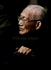 Asian man watching busker