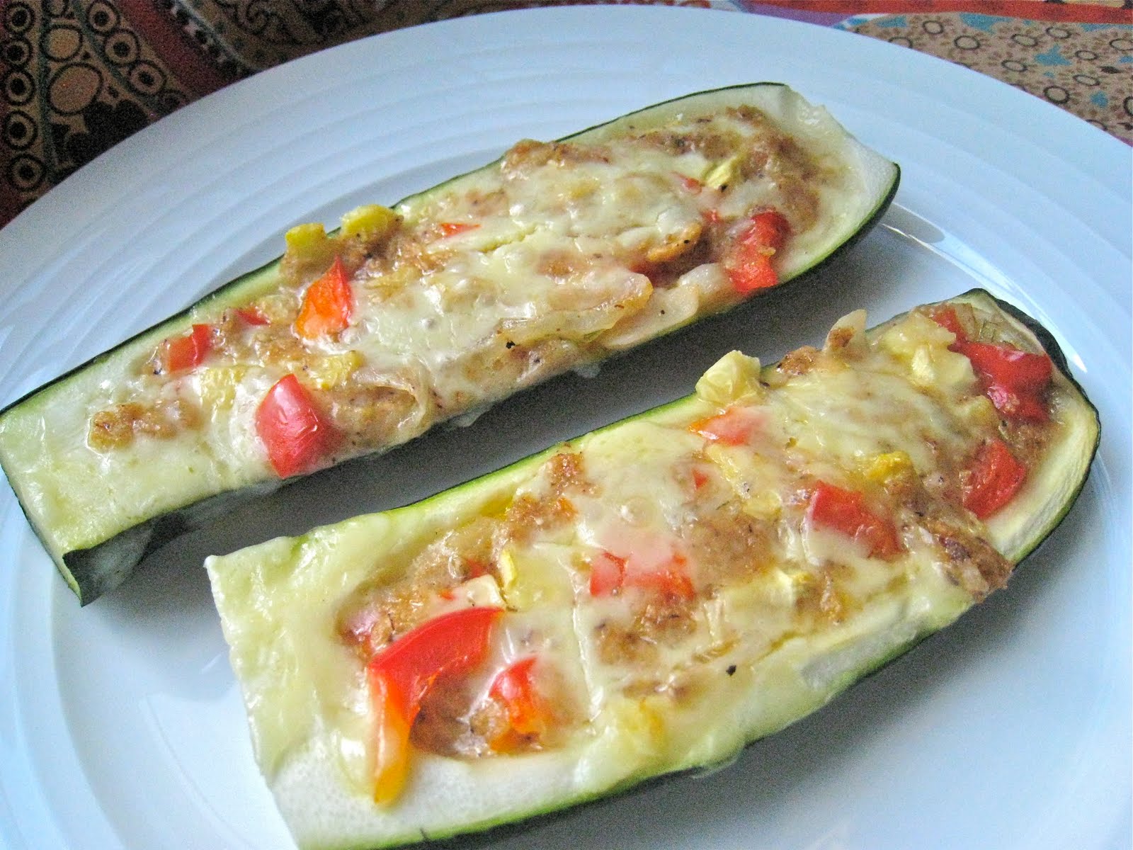 Veggies, Spice and Everything Rice Stuffed Zucchini Boats with melted