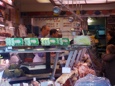 Mother and son shopping at the Butcher