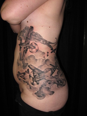 Fighter plane rib tattoo.