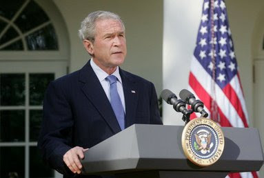 Bush speaking at podium in front of White House