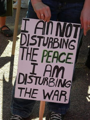 sign that says I'm Not Disturbing the Peace. I'm disturbing the war.