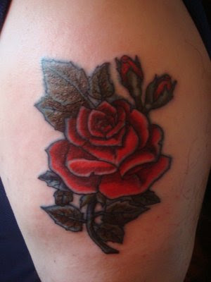 Black tribal dragon and red rose tattoo on the body. Rose Tattoos