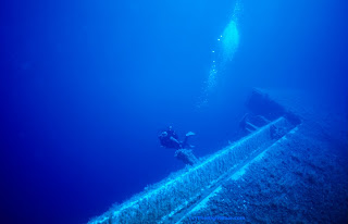 Diver swimming near a shipwreck