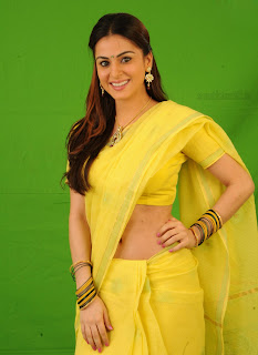 Shradha Arya in Cute Yellow Saree showing Navel