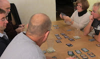 The players in a game of Dominion considering their next action