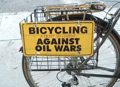 Image of bicycle with bicycling against oil wars plastic plate