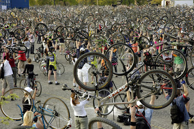Image of Critical Mass cyclists raising bikes