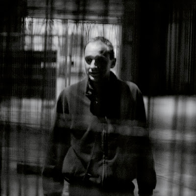 portrait homme derrière des grilles, photo © dominique houcmant
