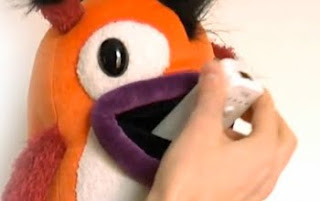 wiiwaa stuffed toy having wii remote pushed into his mouth