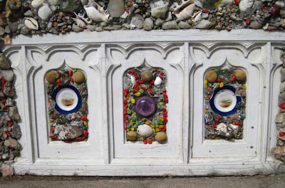 White wooden ecclesiastical panels with stones, glass and plates attached